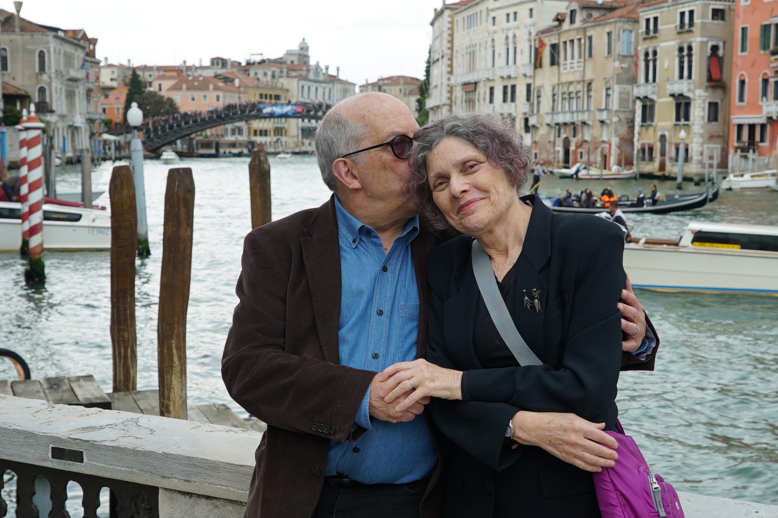 David kissing the side of a woman's head beside the Grand Canal in Venice
