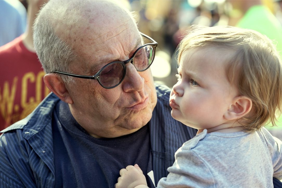 David and a baby looking closely at each other