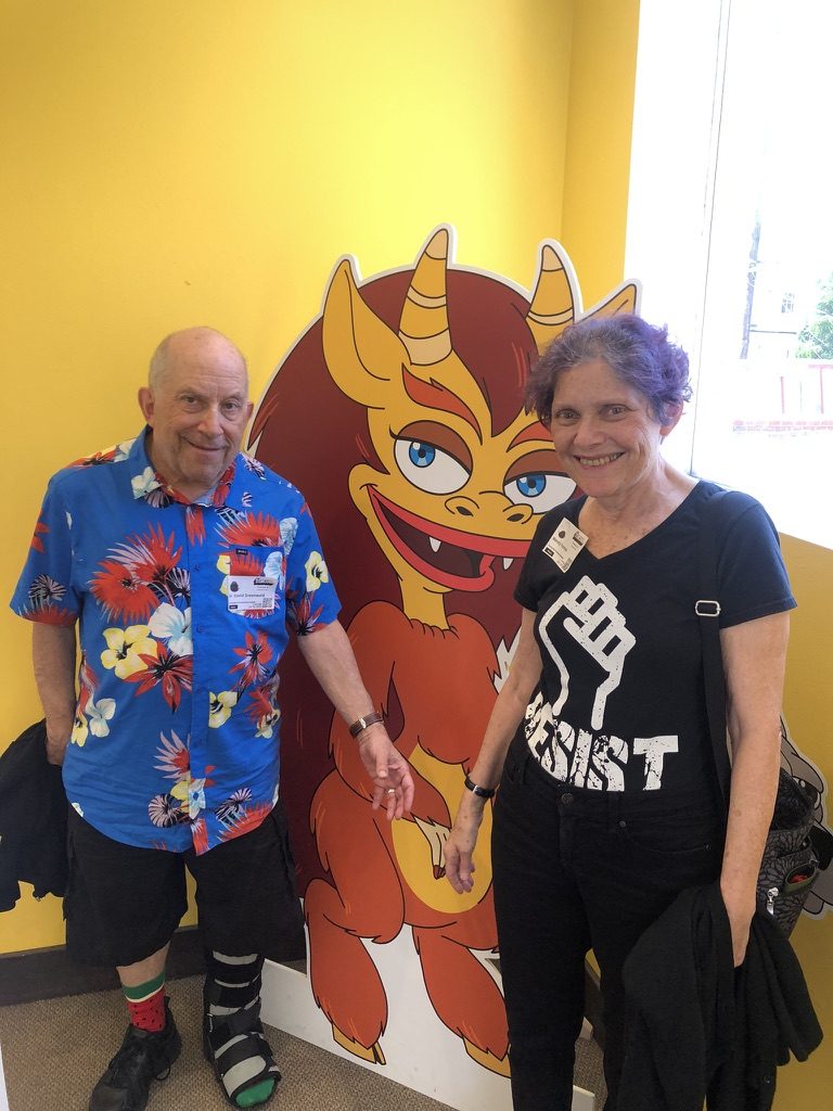 David and a woman standing beside a cartoon cutout