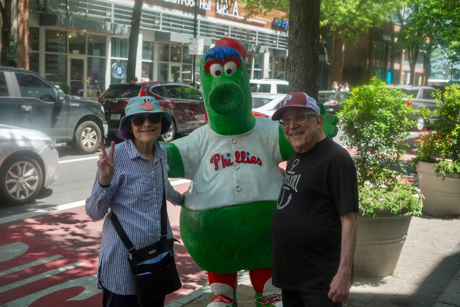 David and a woman posing with the Phillie Phanatic statue