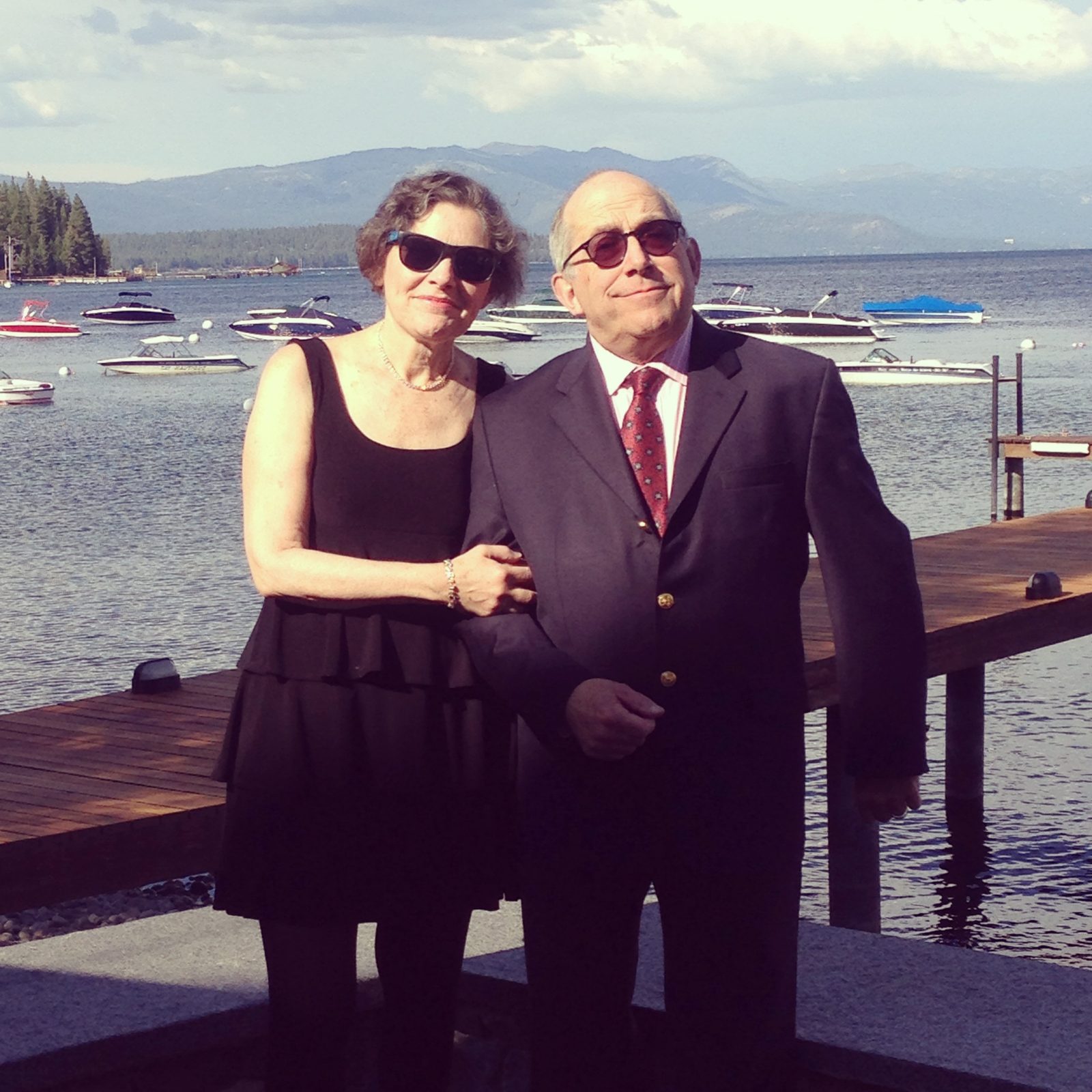 David and a woman standing in front of a lake with boats
